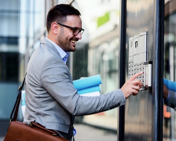 Man pushing the button and talking on the intercom