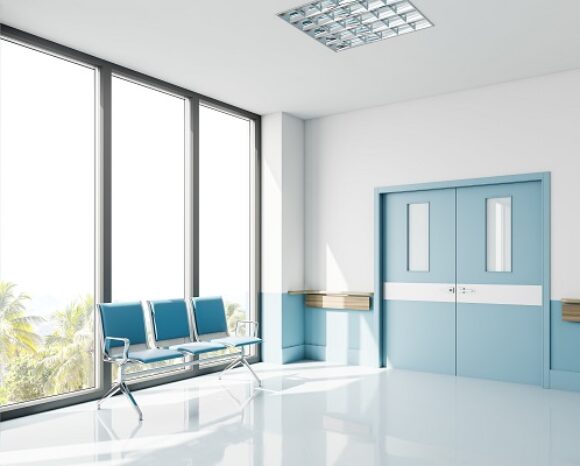 Blue chairs near window in empty hospital hall